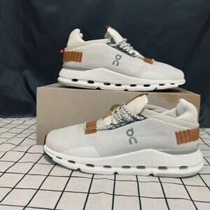 On Running White and Tan Sneakers with Modern Silhouette